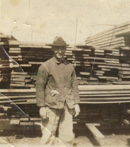 Carl Weinman by lumber. Photo courtesy of Tom Reichard, Carl's grandson.