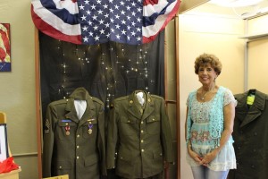 Aleta Weiss by one of the uniform displays. (2015 photo by Karen)