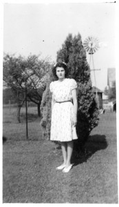 Florence Schumm with windmill and water tank in background. c1944.