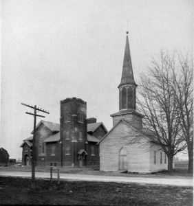 The frame church and the "new" brick church, side-by-side, until the frame structure was moved.